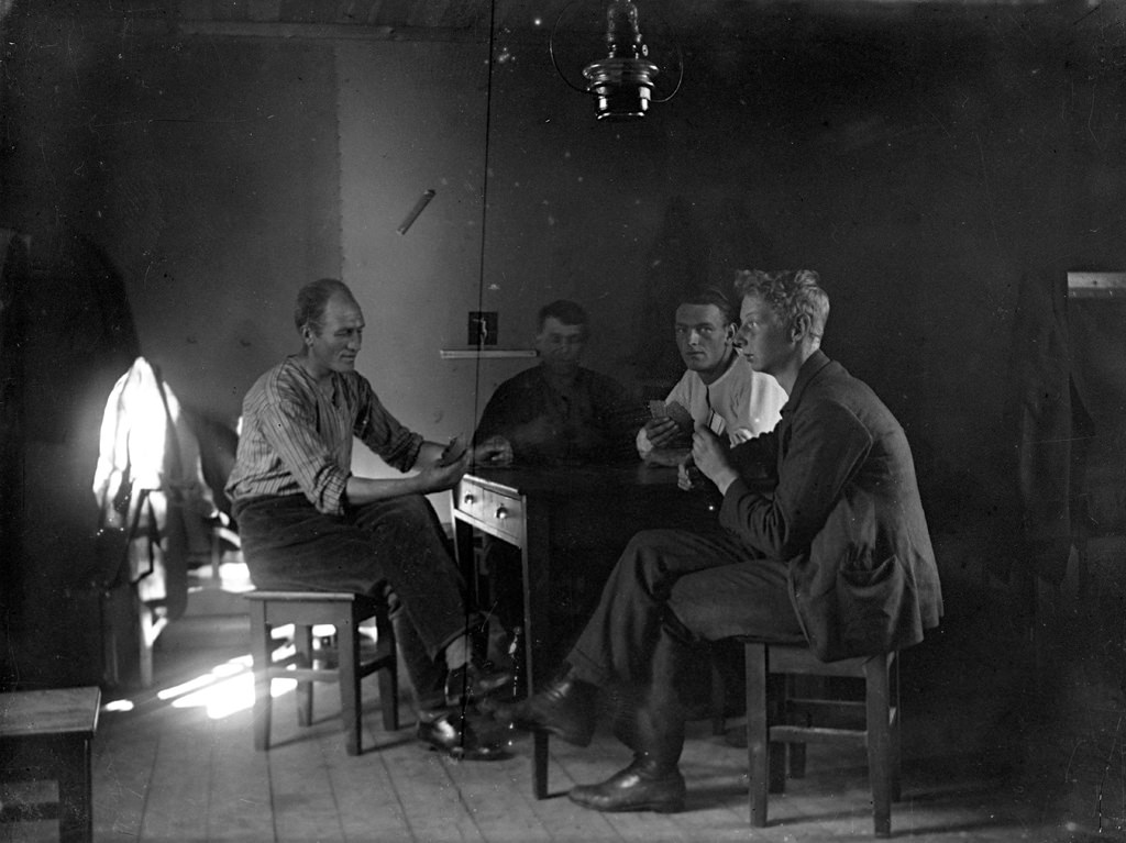 Four men playing cards, ca. 1920s.