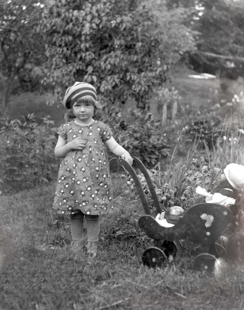 Girl walking with her doll.