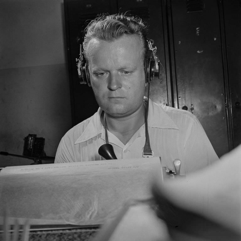 A short wave radio operator receives and records messages from a correspondent in Switzerland.