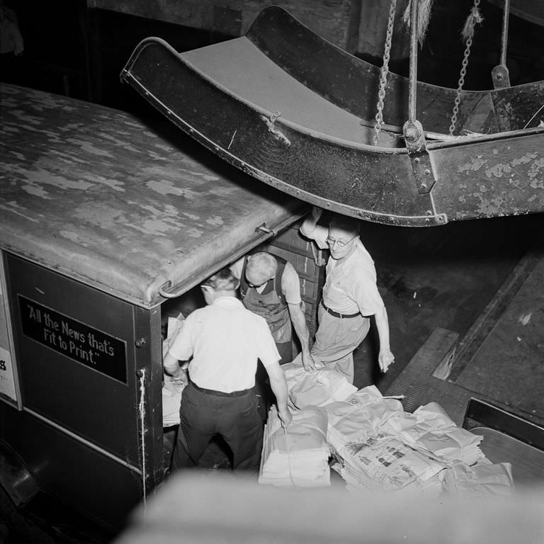 Papers are loaded onto a truck for distribution.