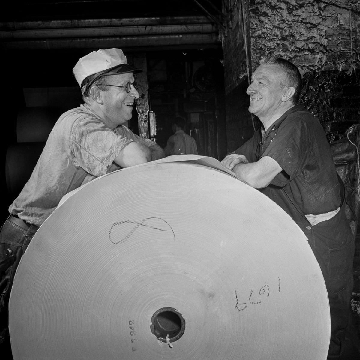 Pressmen relax in the reel room between editions.