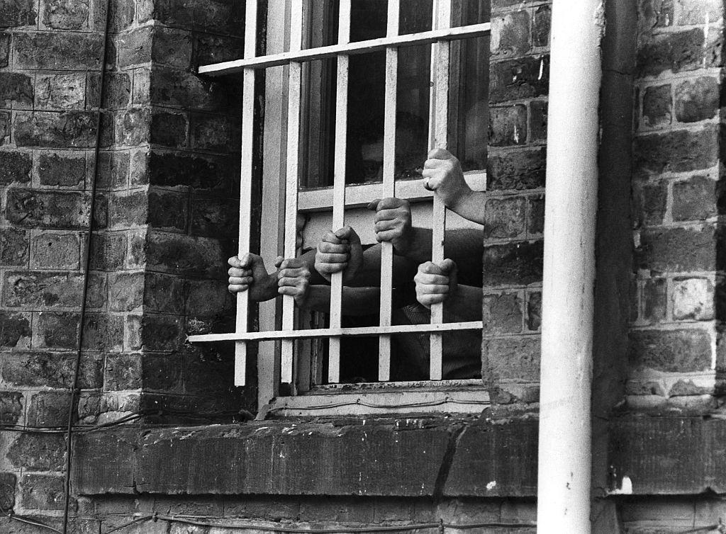 Hands at the bars of a window at Liverpool's Walton Prison, 1975.