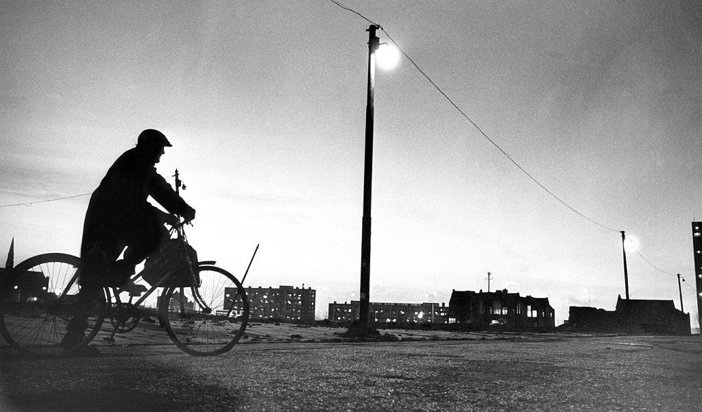 A cyclist taking a break as he rides through wasteland in Everton, bordered by Breck Road and Heyworth Street, Liverpool, 1976.