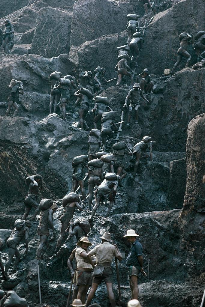 Workers taking the raw material from gold mine.