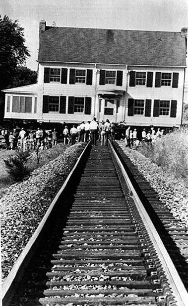 A house being moved in LaCrosse, Wis., stalls on a railroad track, but workers were able to move the structure before a train arrived. September 1974