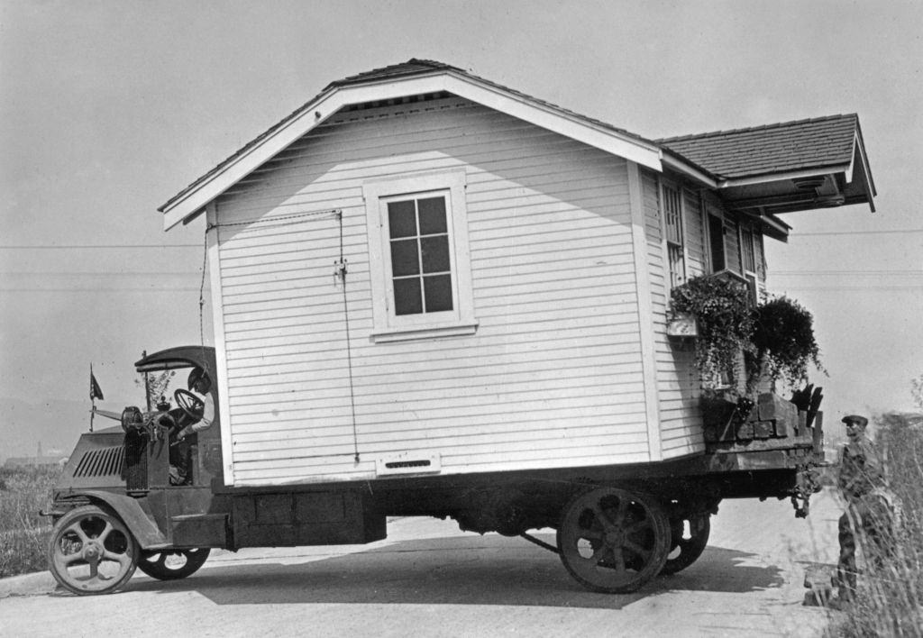 A house moved from Hollywood is elevated to clear its new neighbor's roof on East 90th Street. Aug. 31, 1958