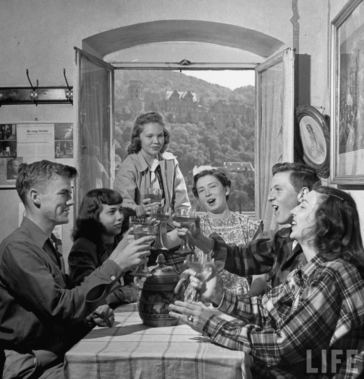 American teenagers drink toast in small inn.