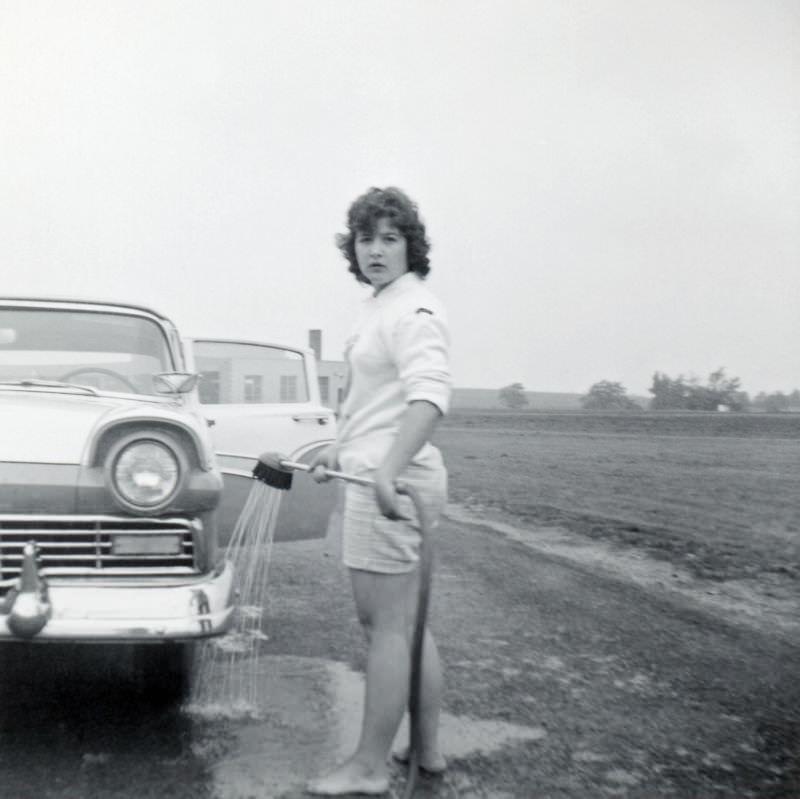 Girl is washing a Ford