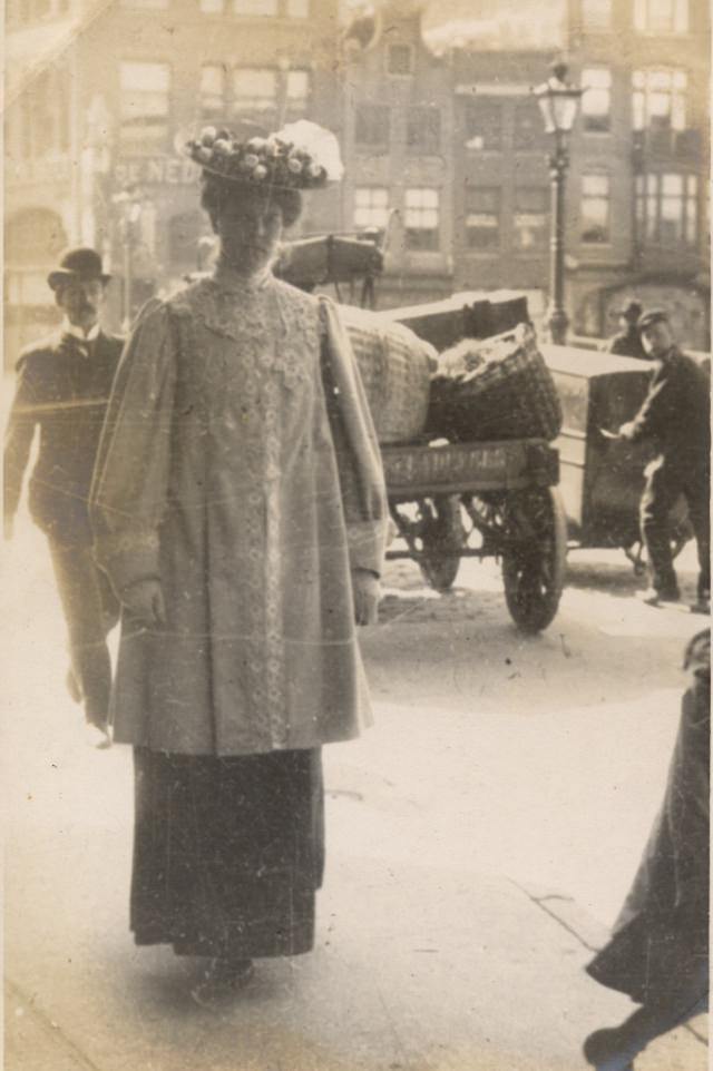 Although the picture has faded with age it is still a good street scene especially the curious man in the background not looking where he’s going.