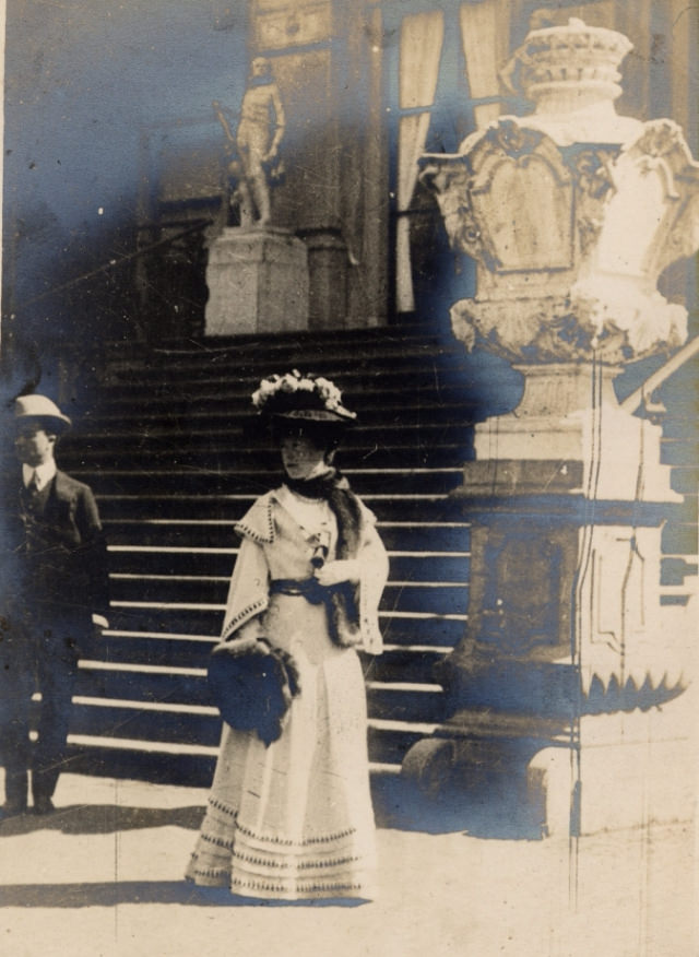 Here in The Hague a lone woman waits outside a grand building.