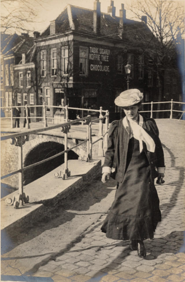 An excellent view of a woman crossing over one of the canals.