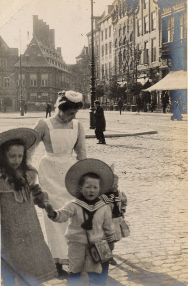 And in this picture, his interest is probably in the uniform of the nursery maid, but we can also see some characteristic Dutch architecture.