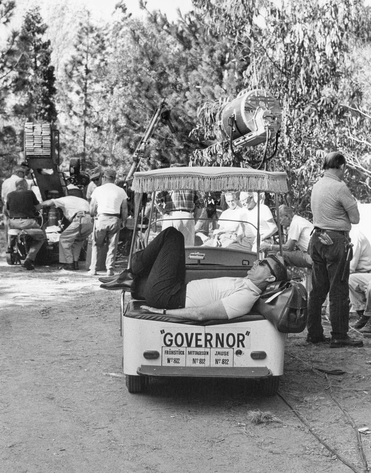 Director Blake Edwards grabs a nap in a golf cart on location in Salzburg, Germany, for "The Great Race," 1964