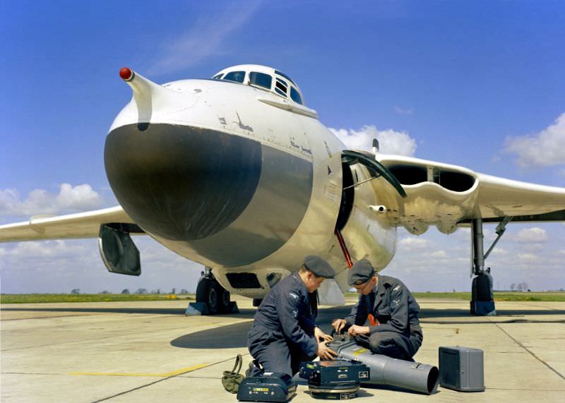 Two senior aircraftmen check an F.52 camera before placing it in a Vickers Valiant B(PR).1 aircraft of No. 543 Photo Reconnaissance Squadron RAF's base at Wyton, Cambridgeshire, 1959