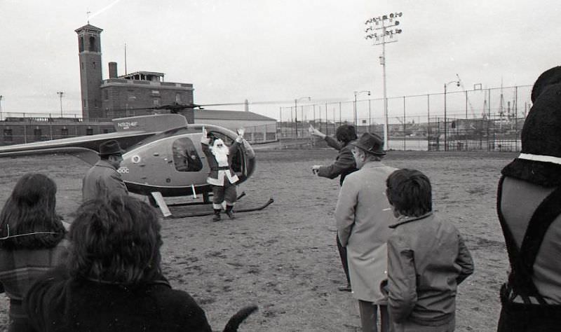 Santa arrives at North End Christmas Party and Parade in a helicopter