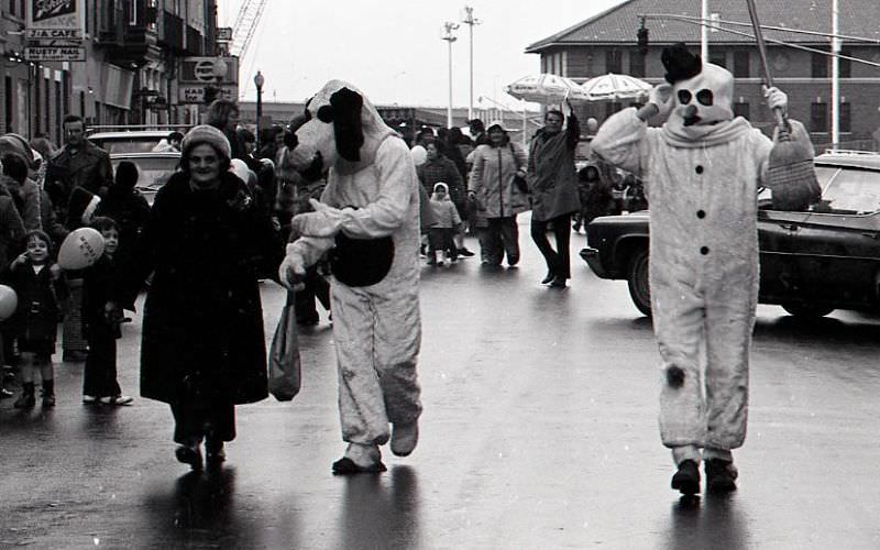 Characters in costume march in North End Christmas Parade