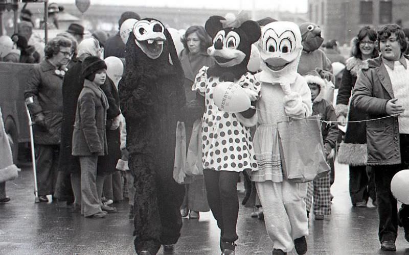 Characters in costume including Minnie Mouse and Donald Duck march in North End Christmas Parade