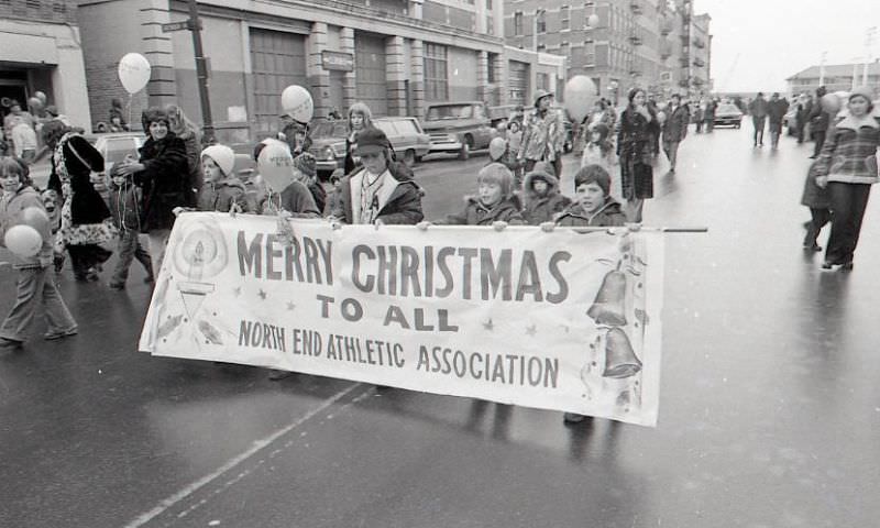 Children with North End Athletic Association banner march in North End Christmas Parade