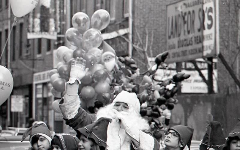 Santa Claus with children dressed as elves in North End Christmas Parade