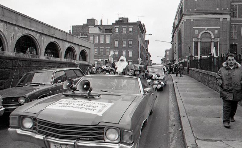 Santa Claus in car with children dressed as elves in North End Christmas Parade