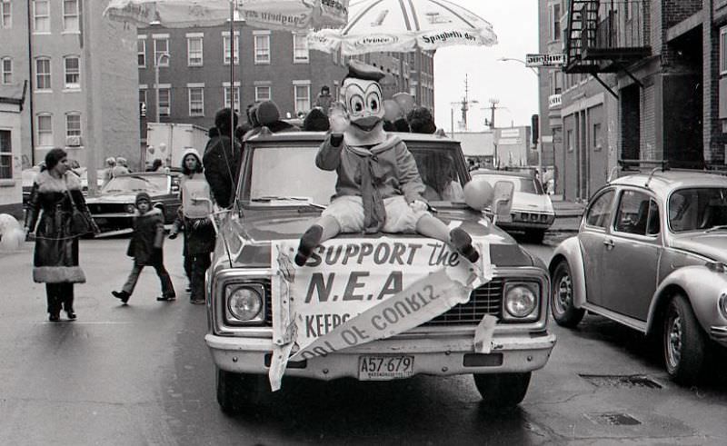 Donald Duck rides on hood of car in North End Christmas Parade