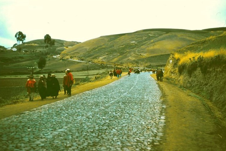 Ecuador. People streaming into market in early morning. Many trot all the way (for miles) with loads on their backs, 1959