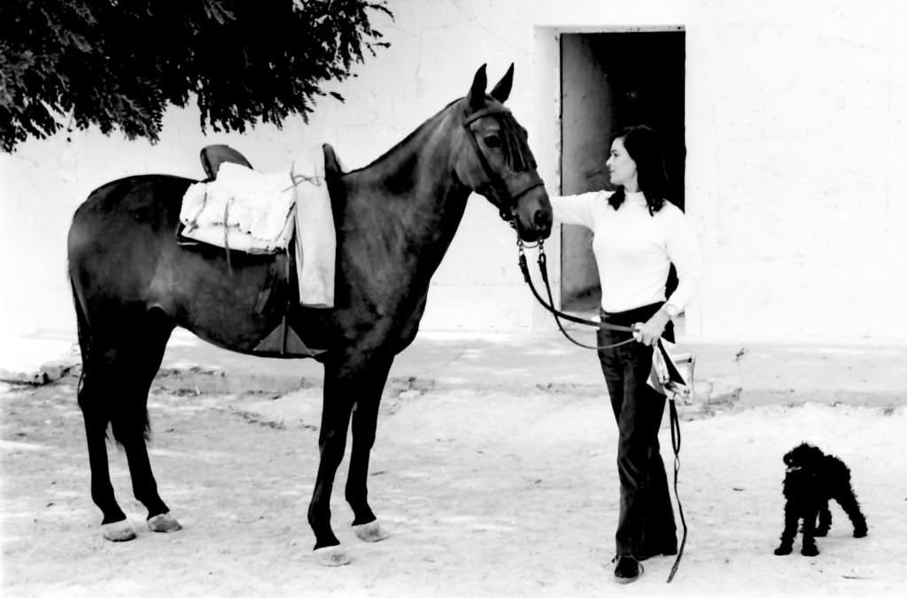 Italian actress Lucia Bose with her horse on her farm of Villa Paz, Saelices, Cuenca, Spain, 1967.