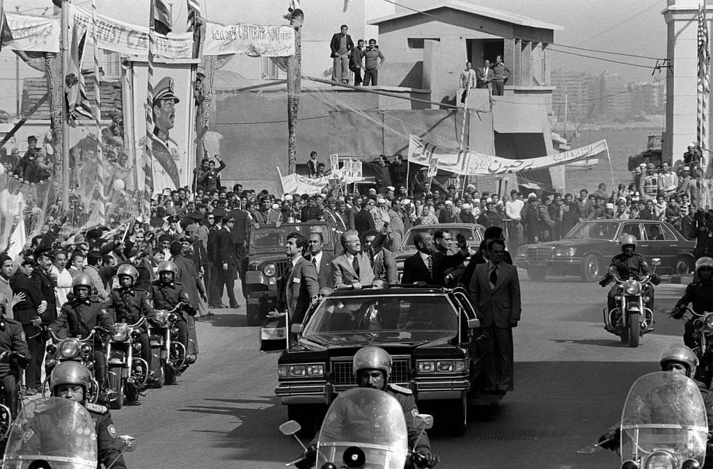 Jimmy Carter and Anwar el-Sadat wave to the crowd during the US President's visit to Cairo, 1979