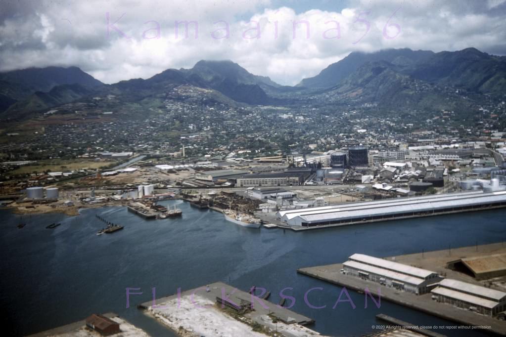 Slightly shaky but nicely detailed airplane view of the west side of Honolulu Harbor looking mauka (inland) from above Sand Island, 1950s