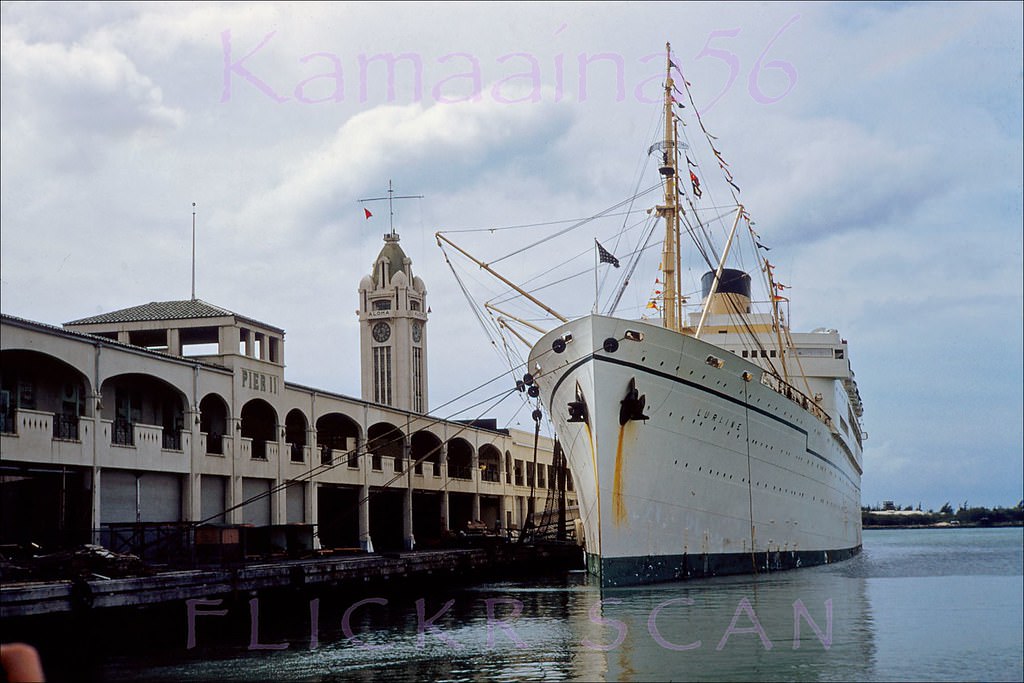 Matson Liner SS Lurline docked at Pier 11 in Honolulu Harbor with the Aloha Tower and Sand Island in the background, 1951