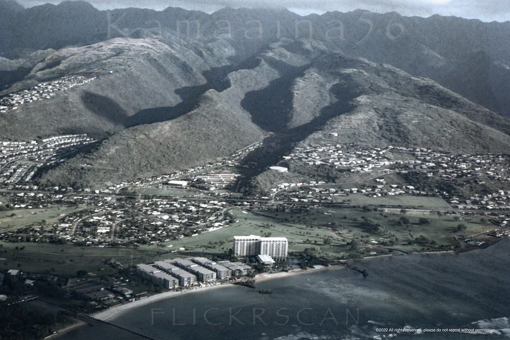 Slightly shaky airplane view over south shore Oahu looking inland at the east Honolulu neighborhoods of Waialae, Kahala, and Kaimuki, 1961