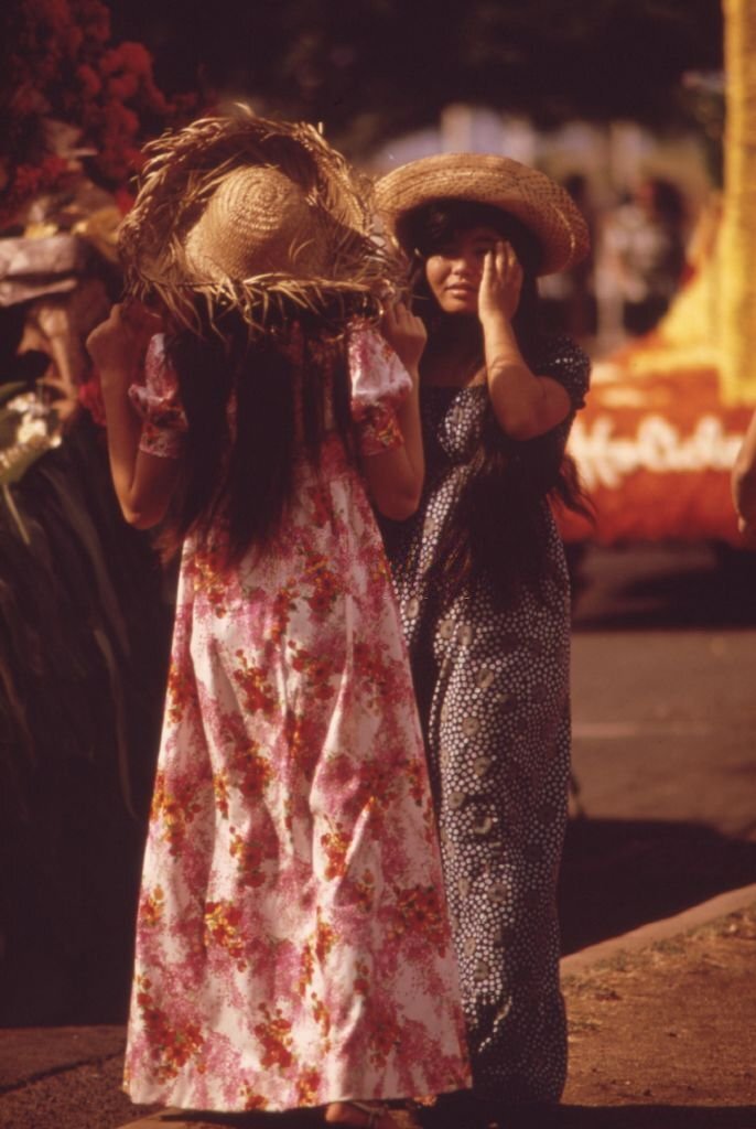Candid full length standing portrait of women dressed for the Aloha Day parade during the annual Aloha Week festivities, Honolulu, Hawaii, October, 1973.