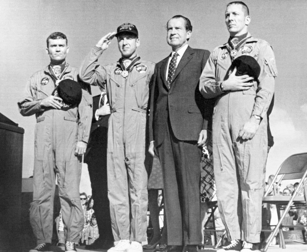 The Apollo 13 astronauts join President Richard Nixon for the playing of the national Anthem during ceremonies.