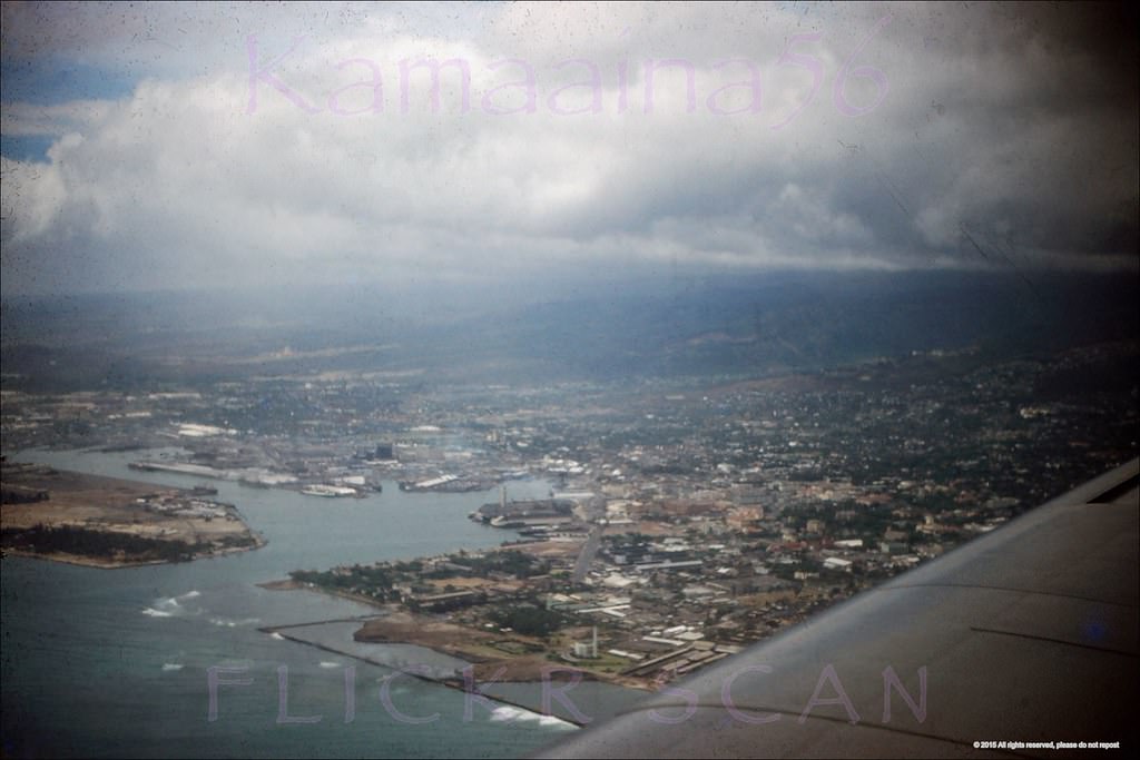 Airplane view over Kakaako heading towards Honolulu Airport, 1952. The entire area out to the breakwaters is now landfill