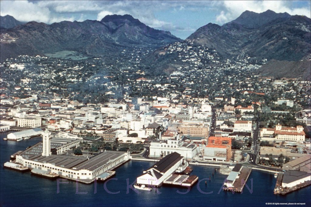 Detailed airplane view of Honolulu Harbor looking inland, 1950s