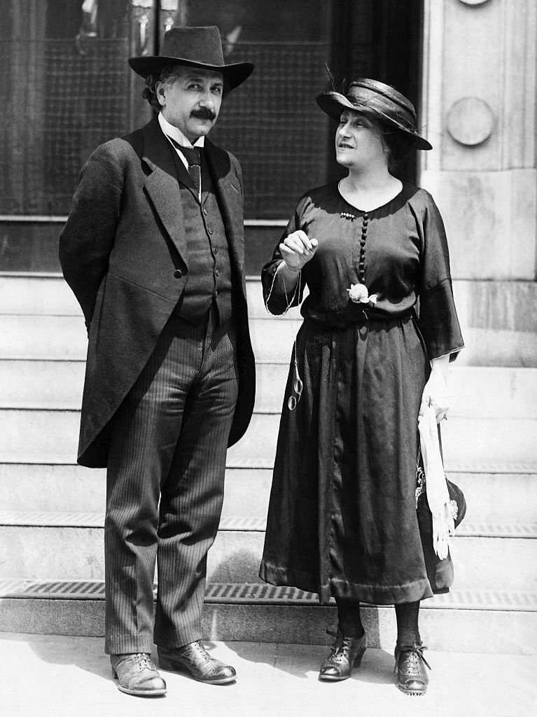 Albert and Elsa Einstein chatting near the steps of building