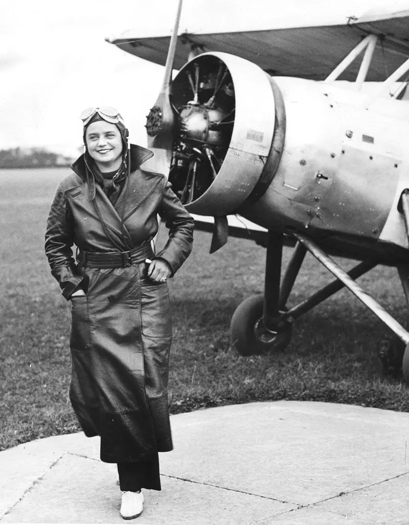 Lady Louise Montagu, daughter of the Duke of Manchester, standing next to her plane, having taken her “A” license and completed a bling flying course, Heaton Airport, Chester. 1934.
