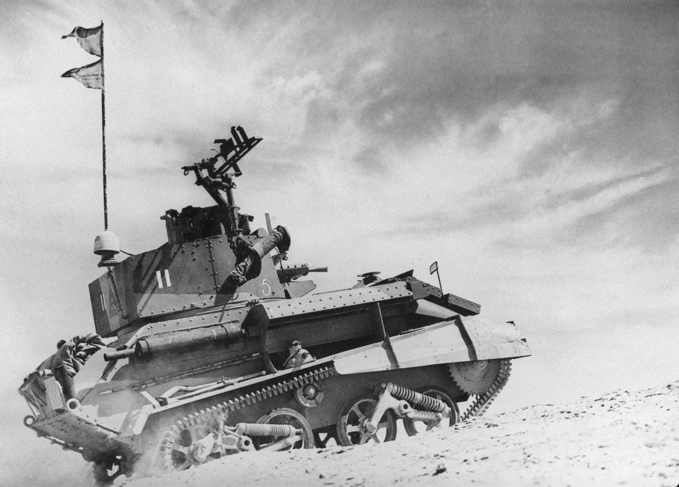 A Vickers Light Tank MkVIb from the 8th (King's Royal Irish) Hussars of the 7th Armored Division, British Army Western Desert Force on patrol in the Egyptian desert near Helmieh on 5th June 1940.