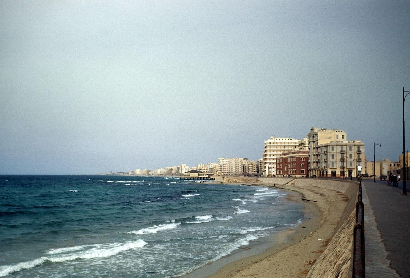 A seaside view of building along the beach in Alexandria, Egypt, 1948