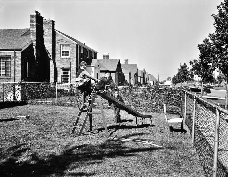 Workers’ children playing in the front yard, Detroit (vicinity), Michigan, September 1942.