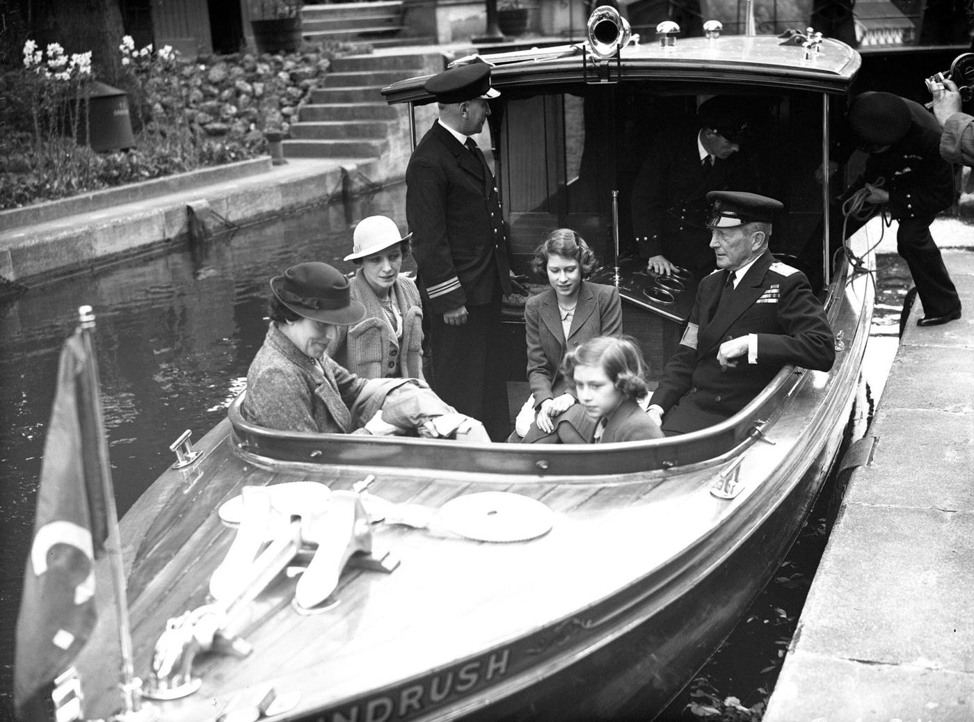 Princess Elizabeth (left, later Queen Elizabeth II) and Princess Margaret with their nurse Marion Crawford on a trip down a river.