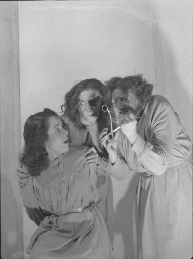 Actors engaging in an eye-gouging scene in a bloody melodrama production at the Grand Guignol Theater.