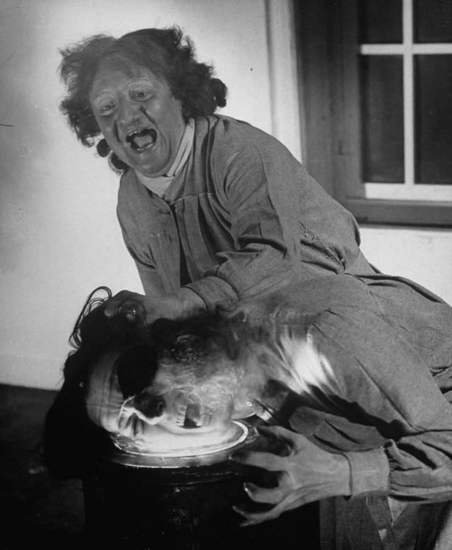 Actors demonstrating the face frying trick in production at the Grand Guignol Theater.