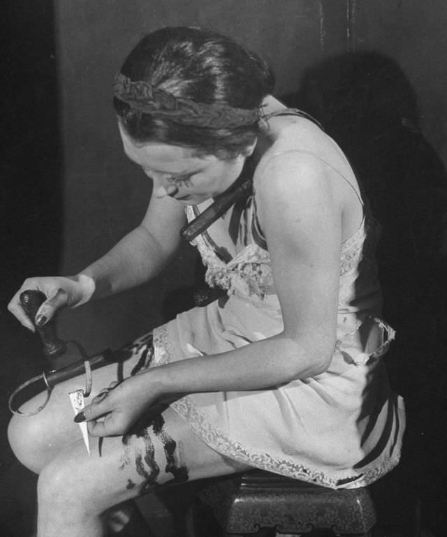 Actress working with a stabbing knife, used for trick in production at the Grand Guignol Theater.