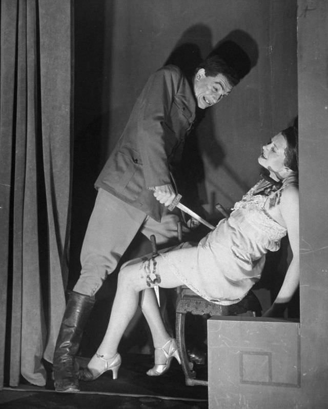 Actor demonstrating the dagger plunging trick in production at the Grand Guignol Theater.