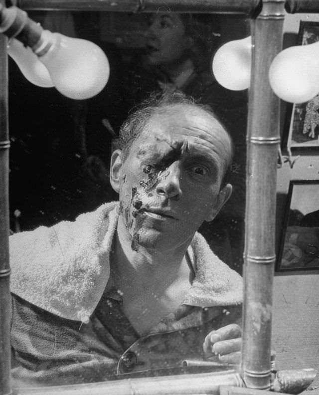 Actor Tony Laurent putting on horror makeup for show at the Grand Guignol Theater.