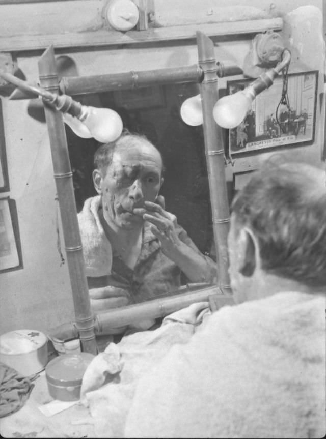 Actor Tony Laurent putting on horror makeup for show at the Grand Guignol Theater.