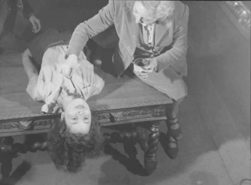 Actor dramatizing the realistic stabbing trick in production at the Grand Guignol Theater.