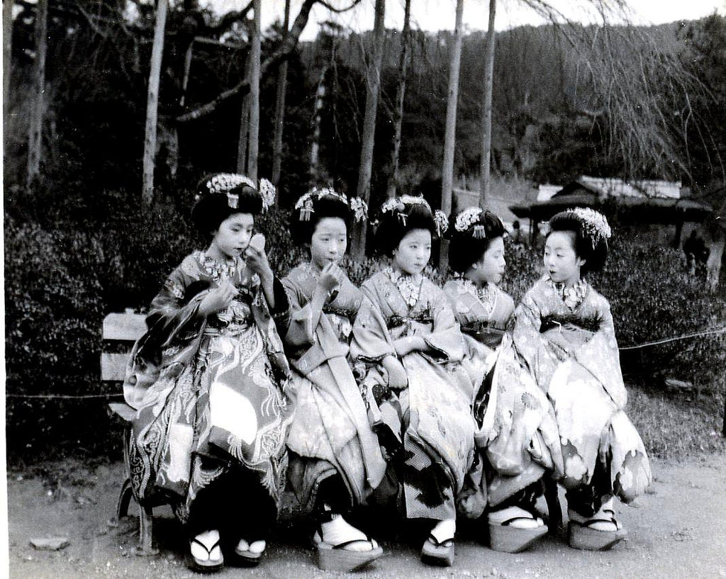 Taking a break and fixing their make-up on a park bench, 1920s