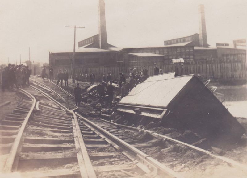 Railroad engine accident after tracks undermined, looking at Pocock Glass Factory, Massillon, Ohio, 1913
